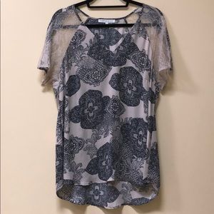 Tan top with lace sleeves and black pattern